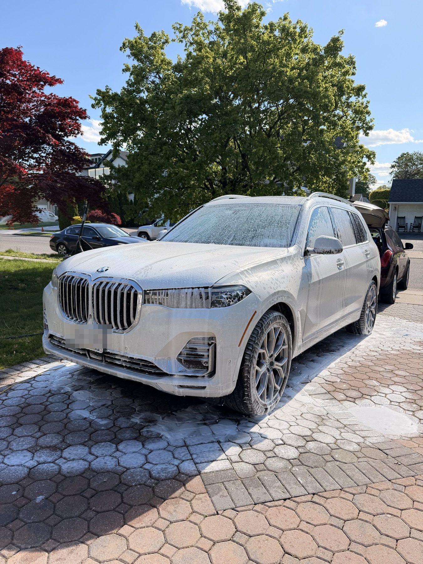 BMW X7 under a full coat of snow foam